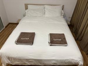 a bed with two brown towels on top of it at Sukhumvit​ 101 in Phra Khanong +31 photos