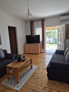 a living room with a couch and a coffee table at Apartmani Andrej in Udbina