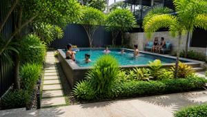 a group of people in a swimming pool at Orange Sky Inn in Canacona