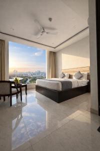 a bedroom with a large bed and a large window at Hotel Near North View Park Zirakpur!! Best Budget Stay !!Free Parking!!Ambala Highway Chandigarh in Zirakpur