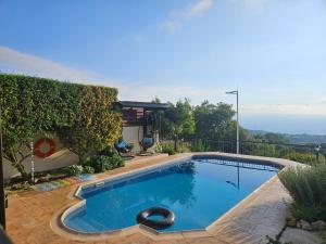 a swimming pool in the yard of a house at Ithaki House in Lyso
