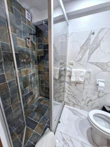 a bathroom with a shower and a toilet at Mirador de la Ñusta in Cusco