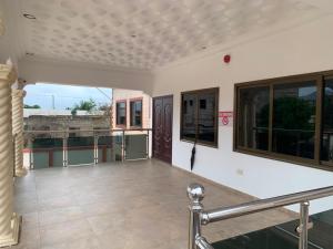 a balcony of a house with a view at Tranquility Lodge in Abrekuma