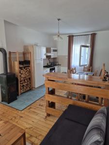 a kitchen with a wooden table and a stove at Apartmani Andrej in Udbina
