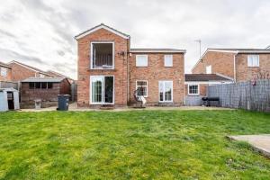 a brick house with a yard in front of it at Bright Double Room with Shared Bathroom in Luton