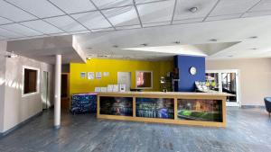 a lobby with a yellow and blue wall at Zemgale in Jelgava