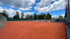 a tennis court with two tennis nets on it at Zemgale in Jelgava