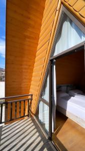 a porch with a bed and a window at Dilijan Tun Boutique Hotel in Dilijan