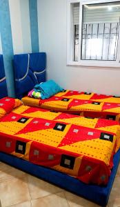 a bedroom with two twin beds with a comforter at Dar Vista Mar in Tétouan +10 photos