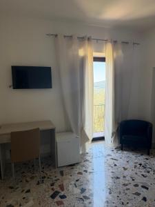 a room with a desk and a window at Dimora Guariglia in San Mauro Cilento +13 photos