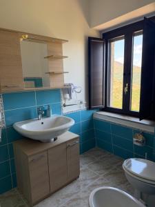 a bathroom with a sink and a toilet at Dimora Guariglia in San Mauro Cilento