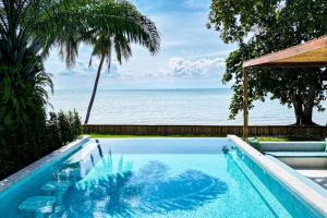 a swimming pool with a view of the ocean at Happy Home kpg in Ko Phangan