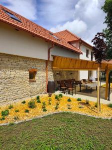a patio of a house with a wooden pergola at Statek u Juzů in Dolní Újezd