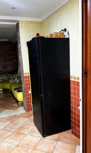 a black refrigerator in a kitchen with a room at Dar Vista Mar in Tétouan