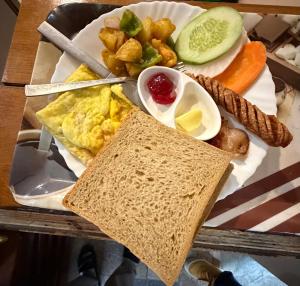 a plate of breakfast food with eggs bread and vegetables at Kathmandu Metro Boutique Hotel in Kathmandu +48 photos