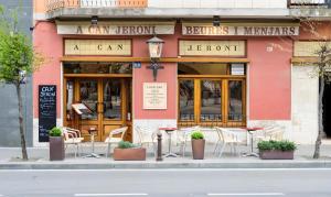 a restaurant with chairs and tables in front of a building at Classic Can Jeroni in Figueres +5 photos