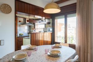 a kitchen with a table with chairs and a clock at Classic Can Jeroni in Figueres
