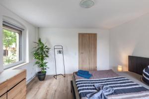 a bedroom with a bed and a plant in it at Andrea Vacation Home in Döbeln