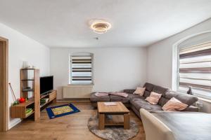a living room with a couch and a table at Andrea Vacation Home in Döbeln