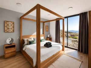 a bedroom with a canopy bed with a large window at Exceptional Villa With Pool in Villaverde +35 photos