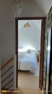 a bedroom with a bed and a large glass doorway at Ty Penty in Riantec