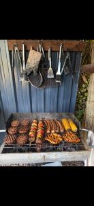 a grill with a bunch of sausages and other foods at Four Seasons Mini Zoo Country Retreat with Wood Fuel Hot Tub close to kington Market Town in Hereford