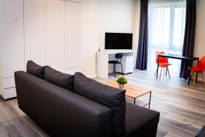 a living room with a couch and a table at Urban76 Apartments in Târgu-Mureş