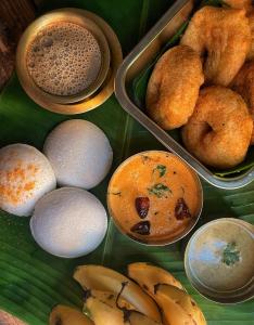 a group of different types of food on a green plate at Laalis crest Coorg Madikeri in Madikeri