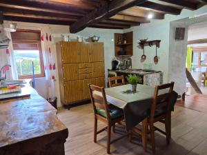 a kitchen with a table and chairs in a room at Casa Do Ivi in Yermo