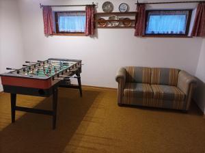 a living room with a table and a couch at Ferienhaus Kuchelberg in Altenmarkt im Pongau