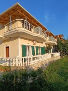 a large house with a balcony on top of it at Lovely Sea View Apartments & Junior Suites in Himare
