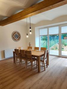 a dining room with a wooden table and chairs at Statek u Juzů in Dolní Újezd