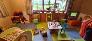 a toy room with a table and chairs and a play room at Landhaus Wildschwendt in Ellmau