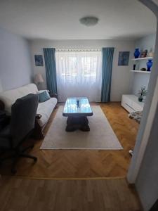 a living room with a table and a couch at Luce in Tomislavgrad