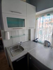 a small kitchen with a sink and a window at Luce in Tomislavgrad