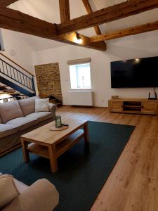 a living room with a couch and a table at Statek u Juzů in Dolní Újezd