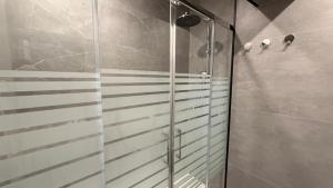 a shower with a glass door in a bathroom at Bela House, By Home Match in Setúbal +43 photos