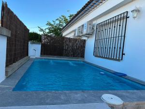 a swimming pool in the backyard of a house at Chalet Rural Alkaluz in Las Eras