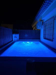 a swimming pool lit up at night at Chalet Rural Alkaluz in Las Eras