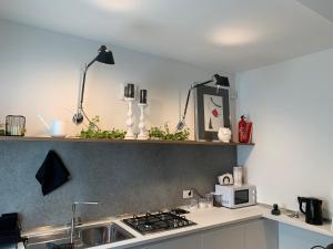 a kitchen with a sink and a stove top oven at Greenway Apartment in Treviso