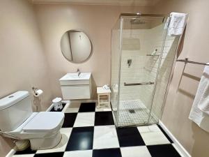 a bathroom with a toilet and a shower at Mont d'Or Franschhoek in Franschhoek