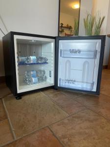 a refrigerator with its door open in a room at La Corte delle Marche in Osimo