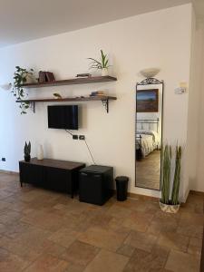 a living room with a mirror and a bed at La Corte delle Marche in Osimo