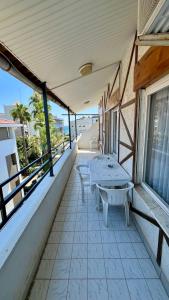 a balcony with two tables and a view of the ocean at Delphin Apart Hotel in Side
