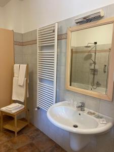 a bathroom with a sink and a mirror and a chair at La Corte delle Marche in Osimo +40 photos