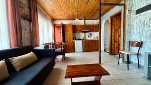 a living room with a couch and a kitchen at Delphin Apart Hotel in Side