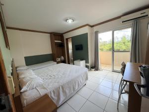 a bedroom with a bed and a large window at CRCN - Golden Dolphin Grand Hotel in Caldas Novas +61 photos