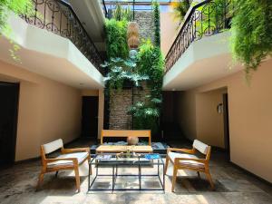 a courtyard with two chairs and a table and a table and chairs at Casa del Alma Hotel Boutique & Spa in San Cristóbal de Las Casas