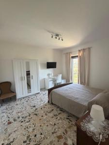 a large bedroom with a bed and a window at Dimora Guariglia in San Mauro Cilento