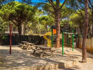 a park with picnic tables and a playground at wecamp L'Escala Punta Milà in L'Escala +51 photos